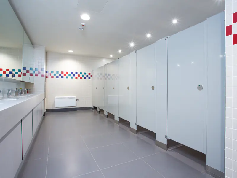 Photo of white powder coated steel toilet partitions