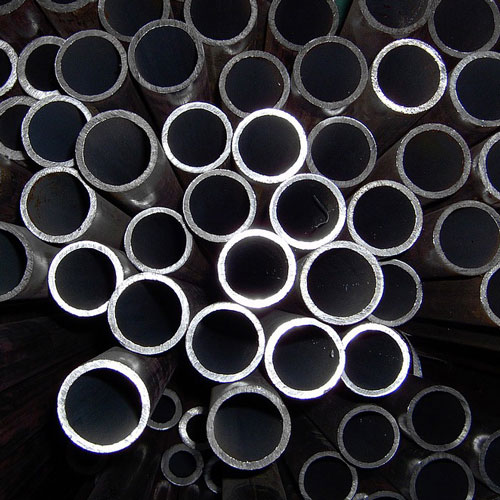 Stylized, high contrast photograph of stainless steel tubing ends, stacked.