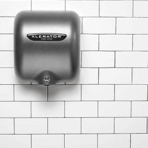 Graphite Textured Painted Excel XLERATOR hand dryer against white tile.
