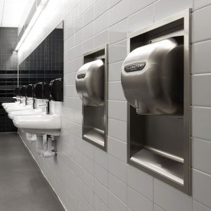 Brushed Stainless Steel XLERATOR hand dryer pictured in contemporary bathroom.