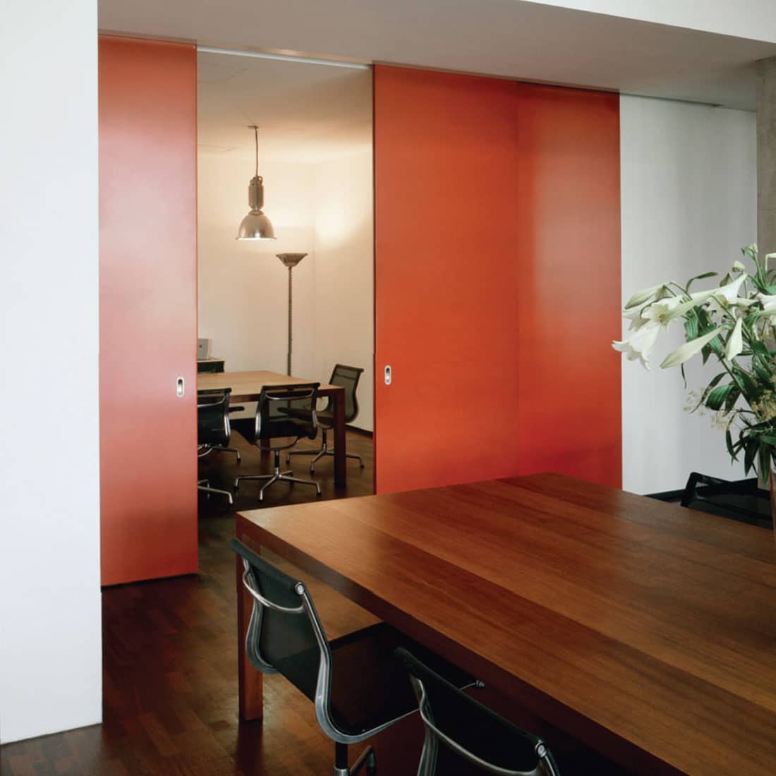 Red HAWA sliding door set between two rooms