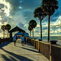 Photograph of an Orlando, Florida pier with trees and clouds.