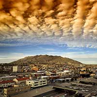 Digitally enhanced photograph of clouds over El Paso, Texas cityscape.