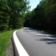 Partition Plus ships powder coated steel partitions quickly! Photo of a road with streaking showing speed.