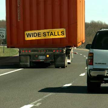 Manipulated photograph showing large truck with “wide stalls” banner.