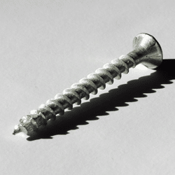 Photograph of metal screw against white.