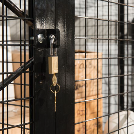 Photograph of a padlock in a hasp on a BeastWire mesh locker door.