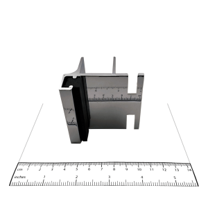 Photograph of keeper from Bobrick In-Swing Door Hardware Kit - 1002038, with ruler.