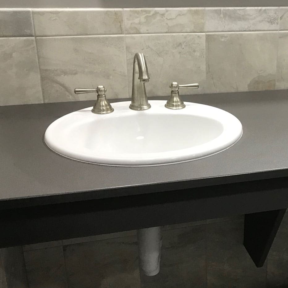 Photograph of a sink bowl and three-piece faucet installed in a Scranton Products HDPE vanity top.