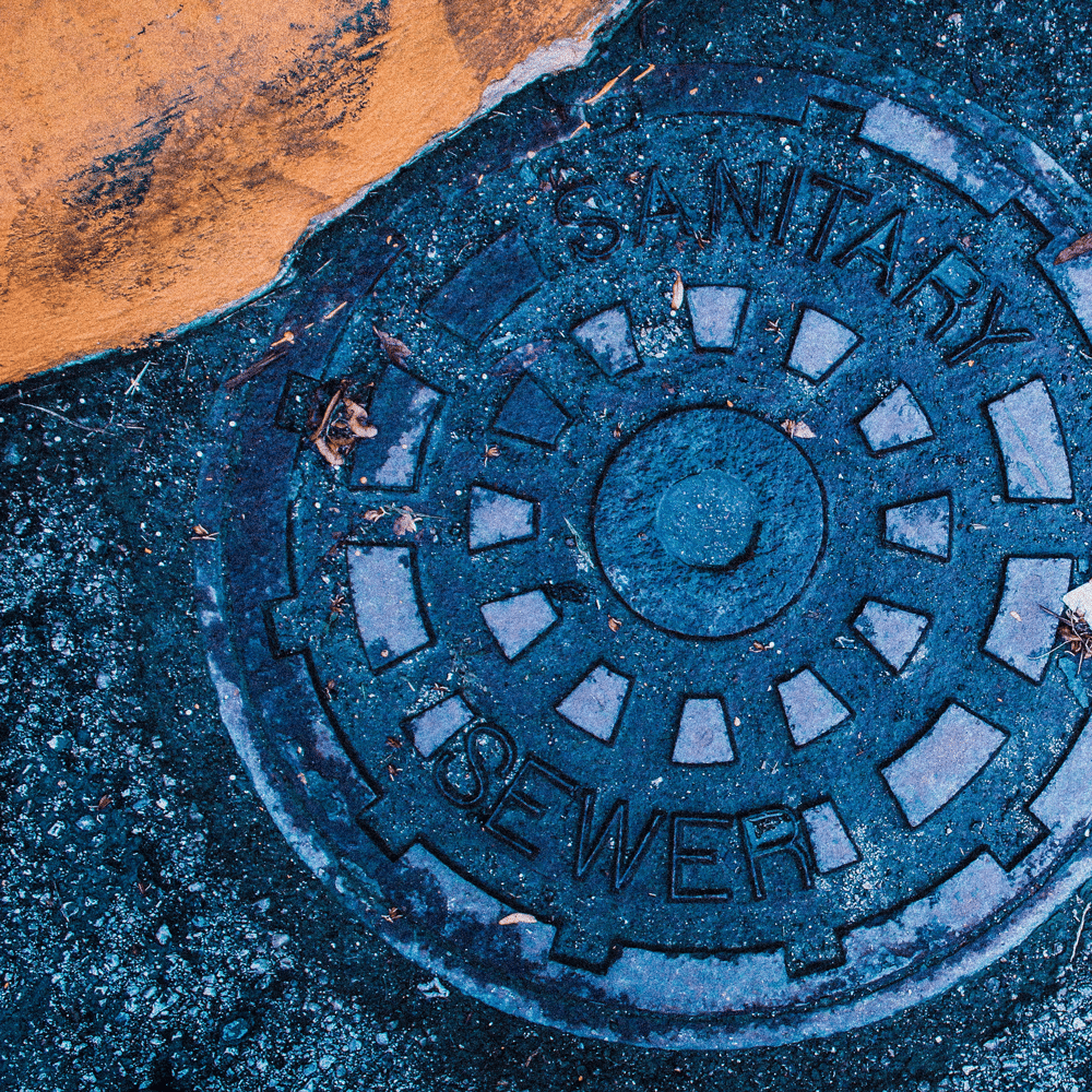 Photograph of a manhole cover for a blog post about wastewater testing.