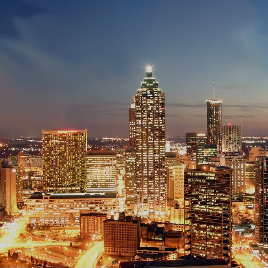 Photograph of Atlanta, Georgia city skyline at night with lights.