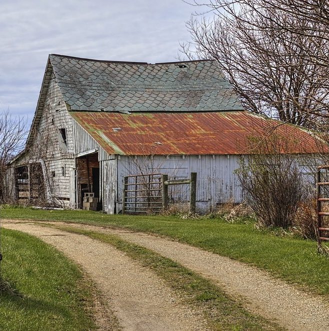 Photograph of old barn and dirt road in Ohio countryside.