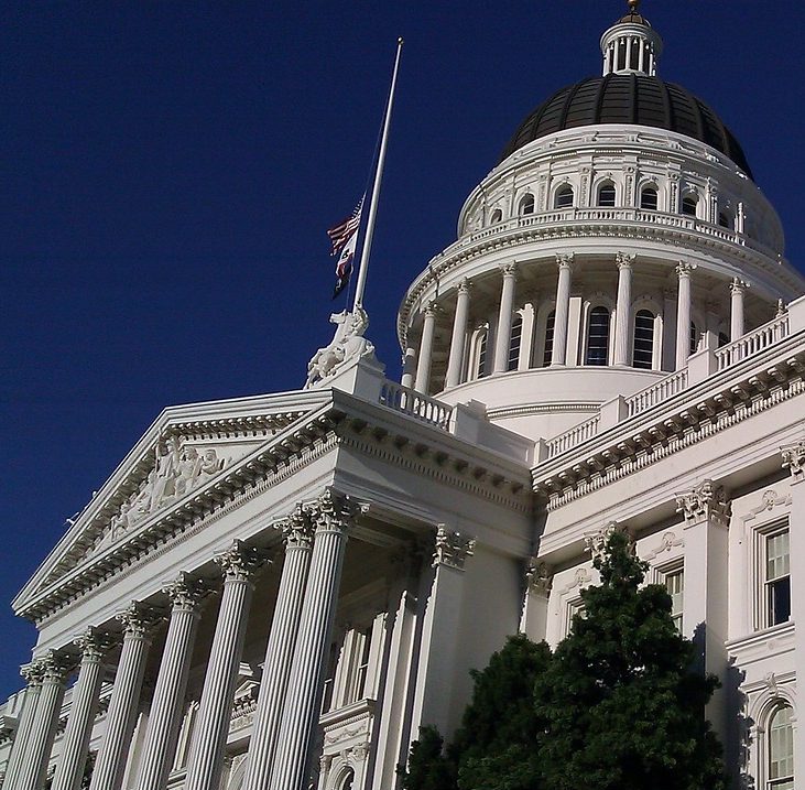 Photograph of large white Sacramento, California capitol building, classical architecture.