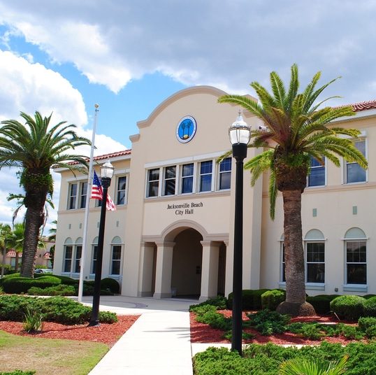 Photo of Jacksonville, Florida city hall with two palm trees.