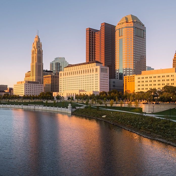 Photograph of Columbus, Ohio skyscrapers near a body of water.