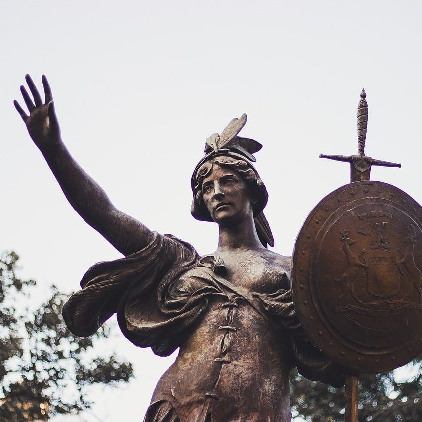 Photograph of dark metal sculpture of female warrior in Detroit.