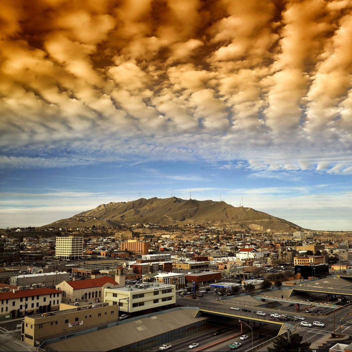 Digitally enhanced photograph of clouds over El Paso, Texas cityscape.