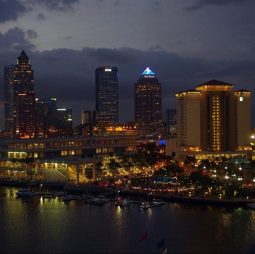 Photograph of Tampa, Florida city skyline at night with lights.