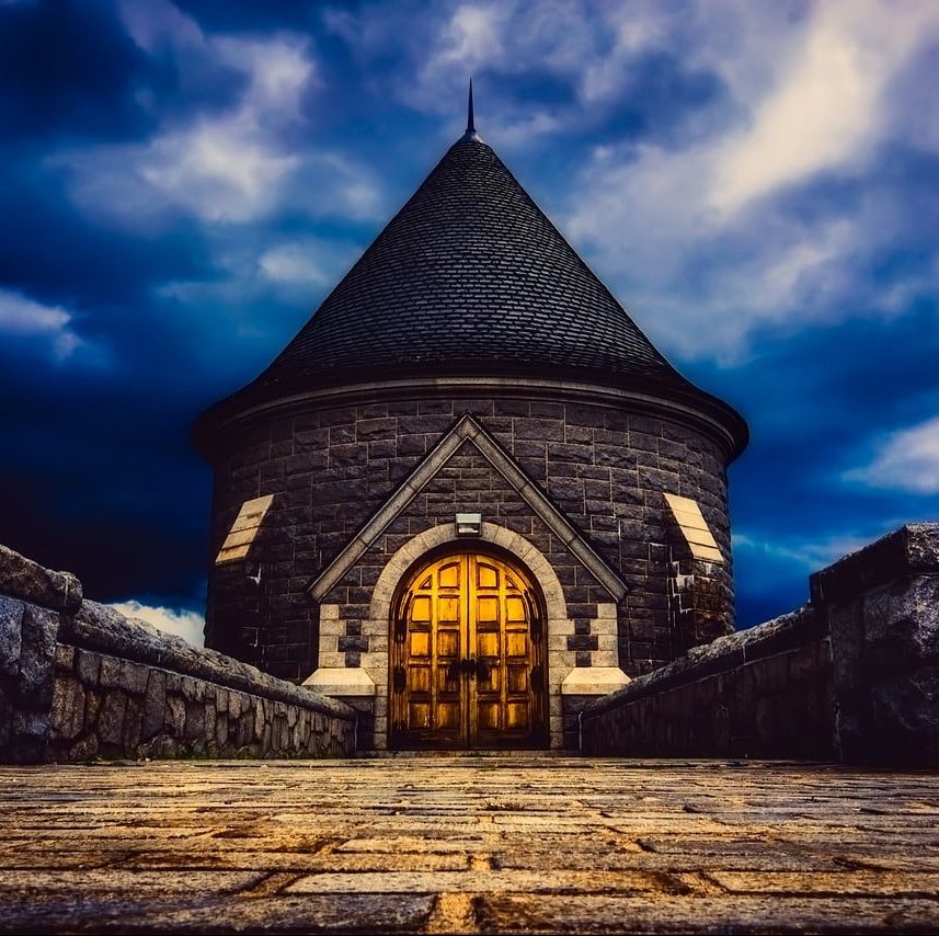 Low angle, nighttime photograph of rounded building near Connecticut dam.