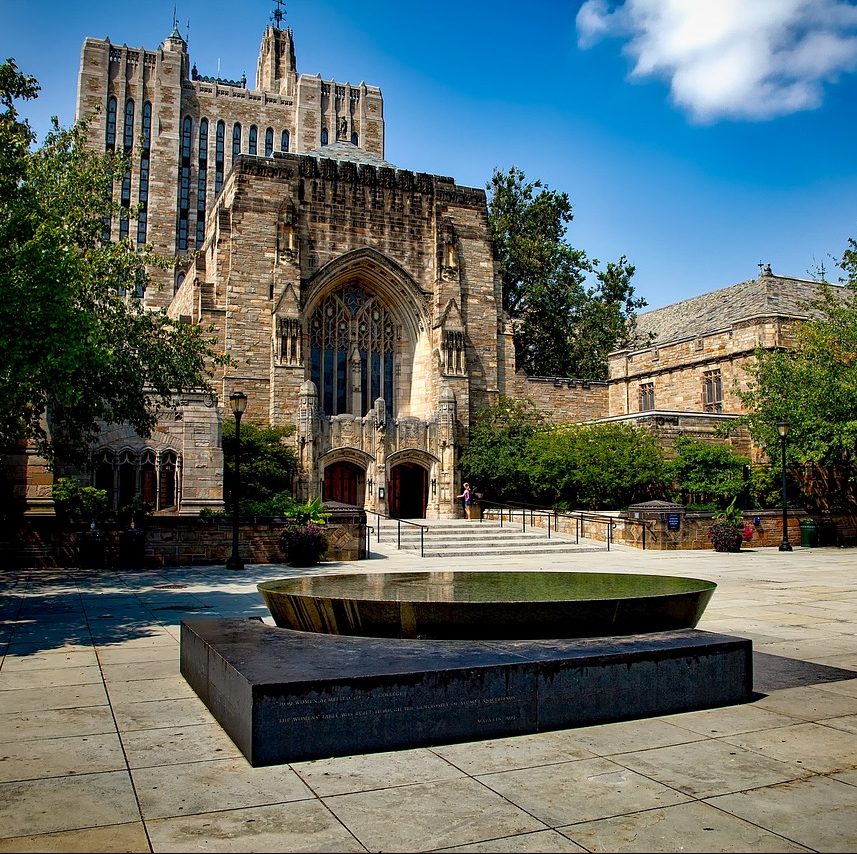 Photograph of a university courtyard and surrounding brick, stone buildings.